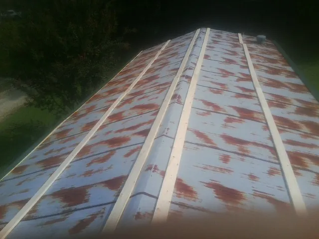 Rusted metal roof panels with new wood purlins before replacement — Storm Damage Roof Repair in San Gregorio by Roofing Brothers