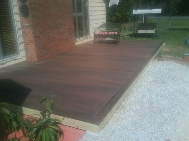 Freshly stained wood deck built against a brick home in San Gregorio