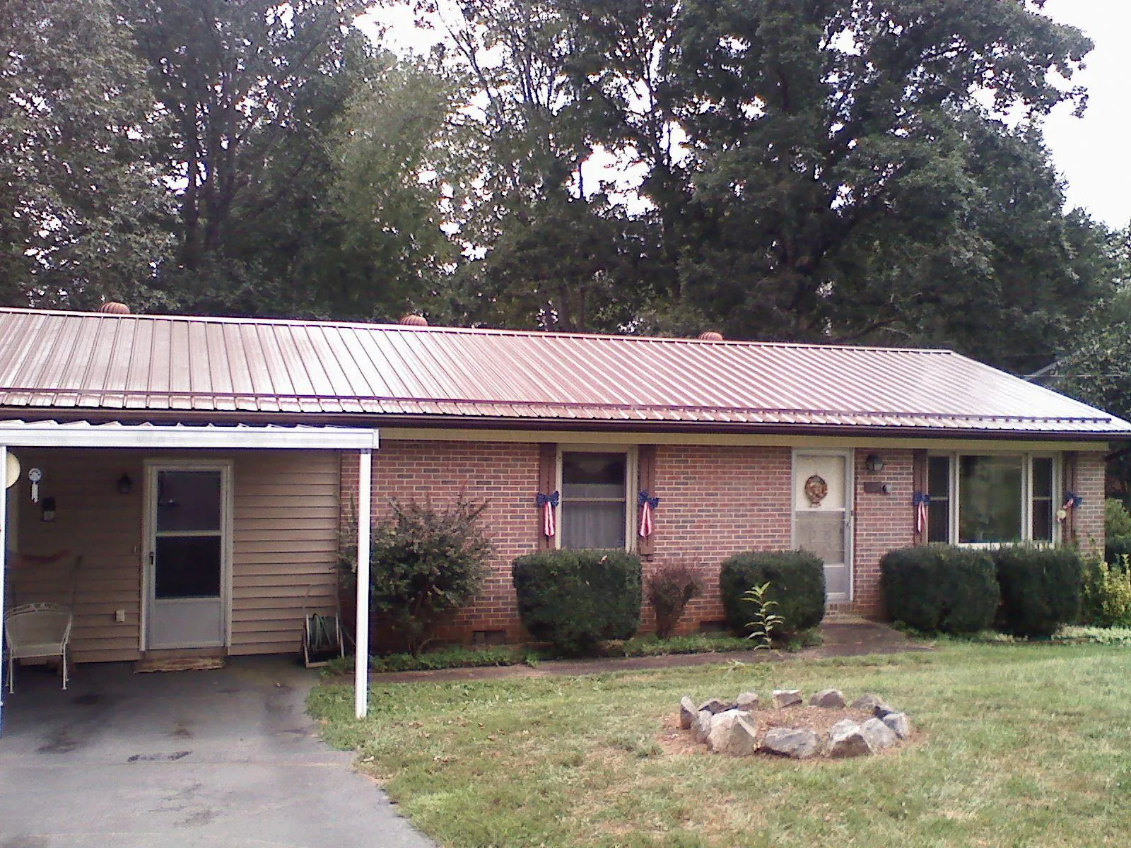 Bronze metal roof and carport on a brick ranch home — Roof Repair work by our crew in San Gregorio