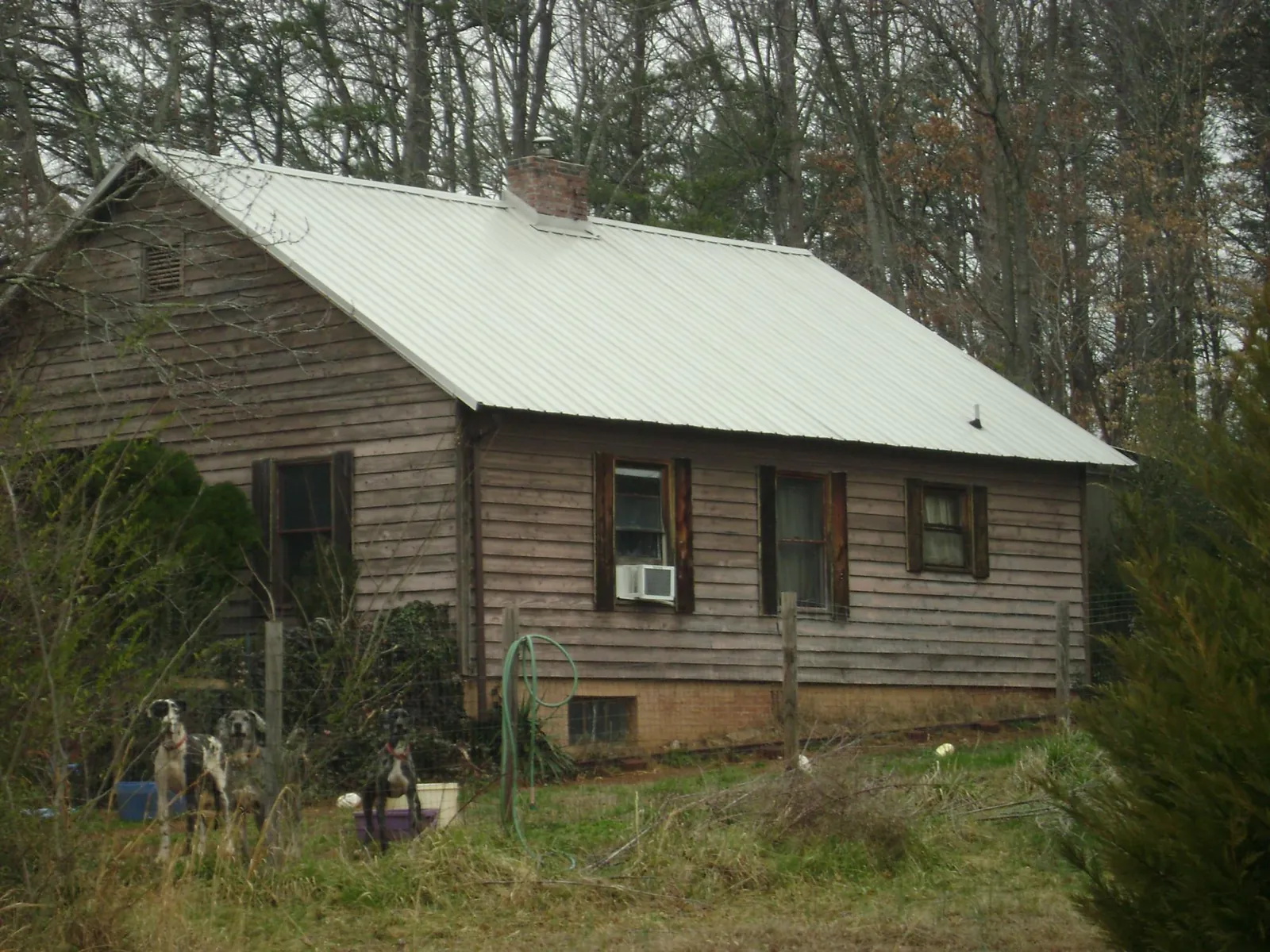 White metal roof on an old wood sided farmhouse, from a Metal Roof Installation job in San Gregorio